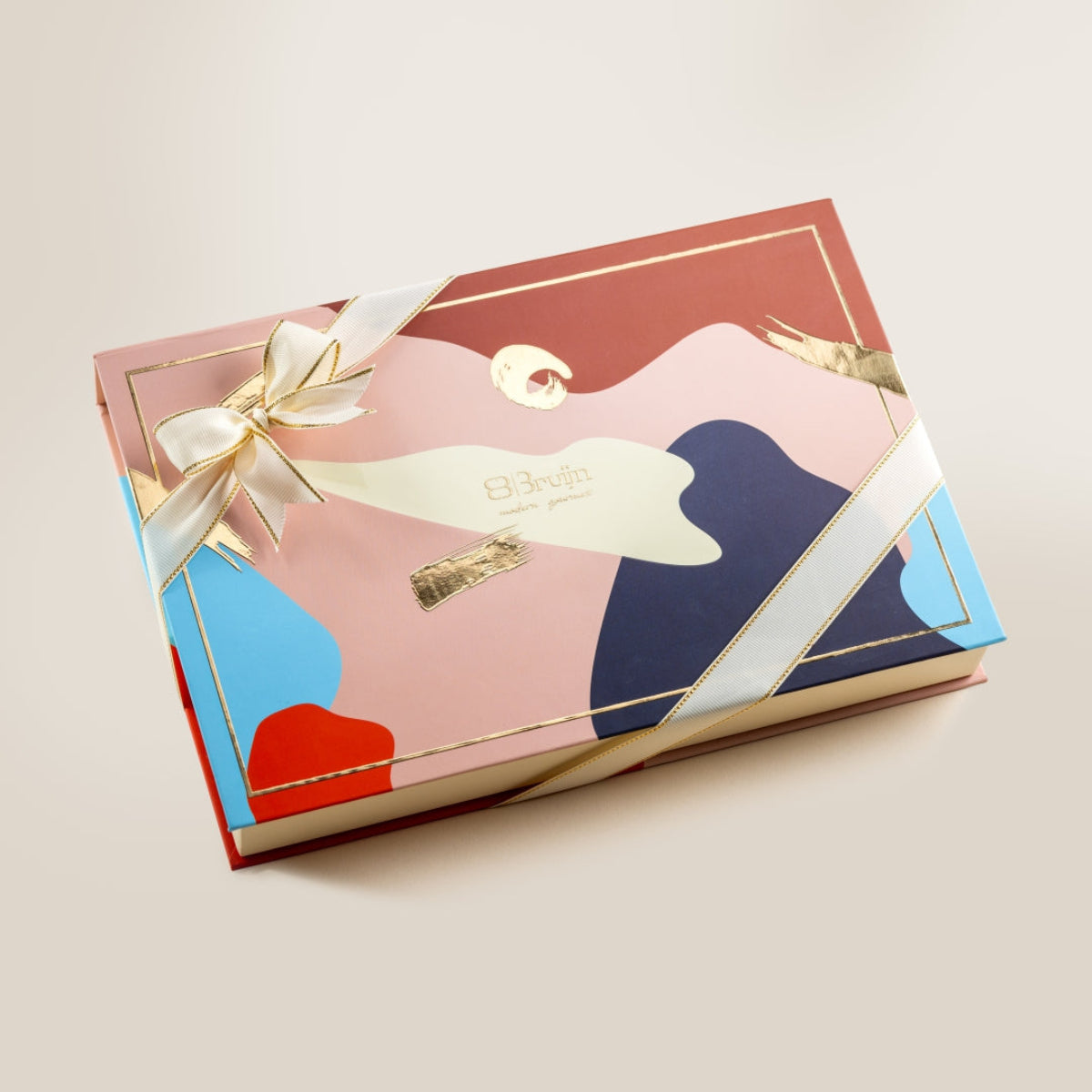 Closed Regal Assorted Box in colorful luxury packaging with ribbon, ideal for weddings and festive gifting.