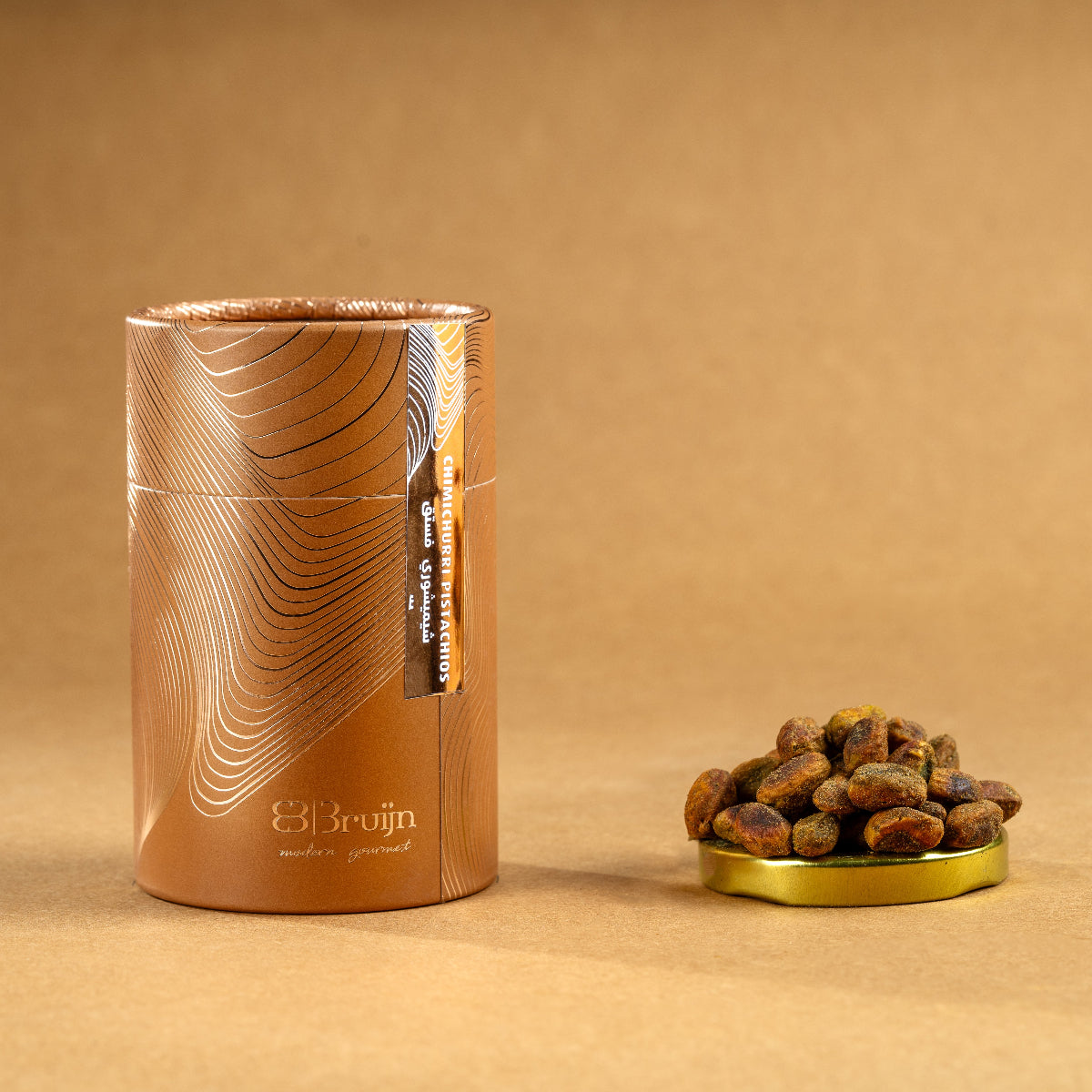Brown cylindrical container of Bruijn Chimichurri Pistachios with minimalist design, containing pistachios coated in herb-rich chimichurri seasoning.