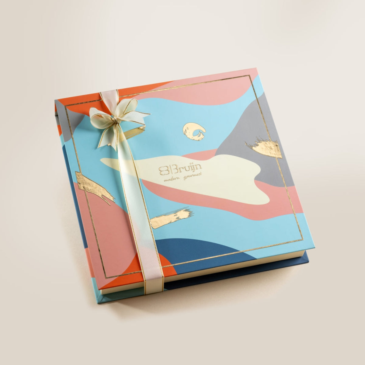Elegant Bruijn Opulent Chocolate Collection gift box with colorful design and golden ribbon.