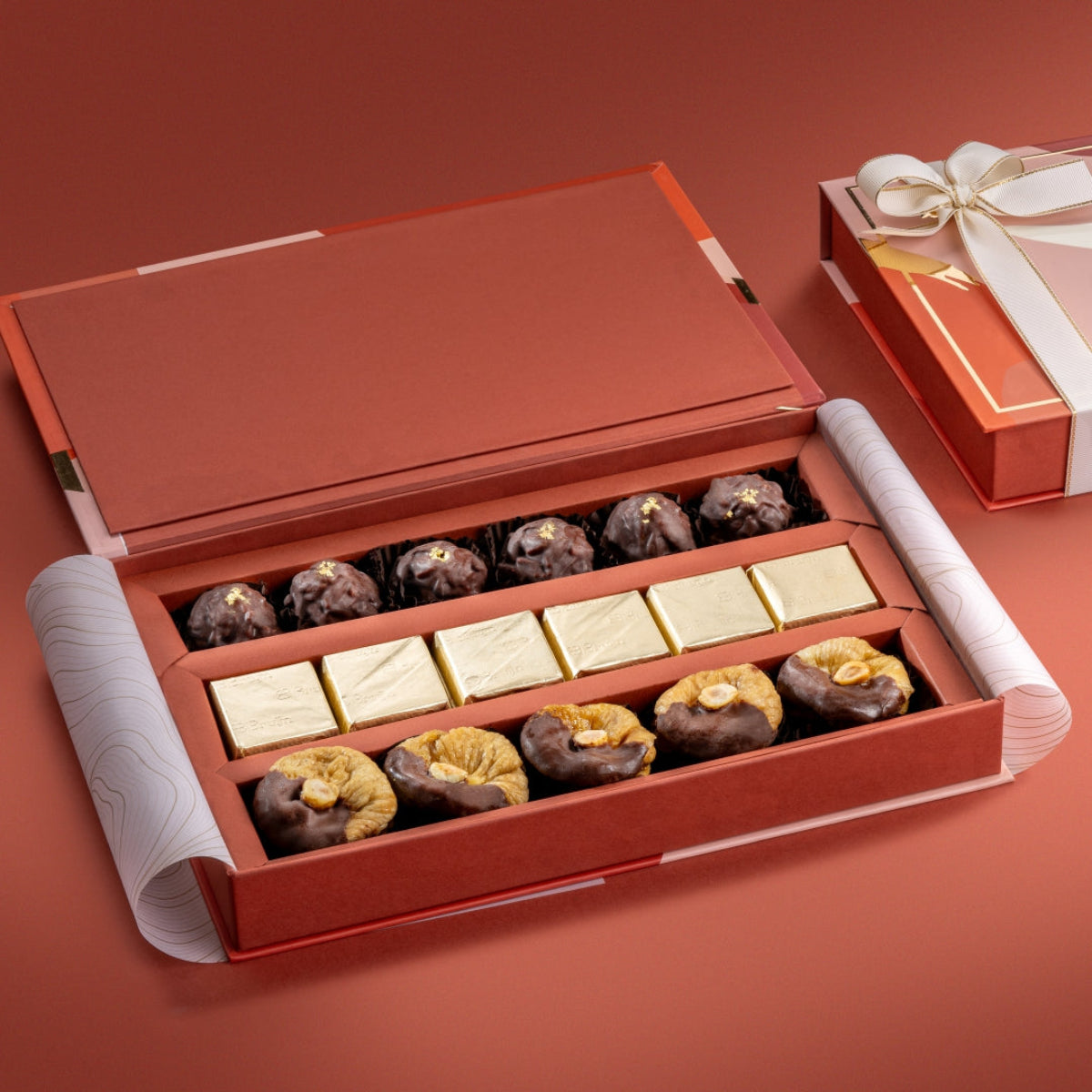 Open Chocolate Trio gift box with 24K almond rocks, pure cacao nut chocolate, and hazelnut figs.