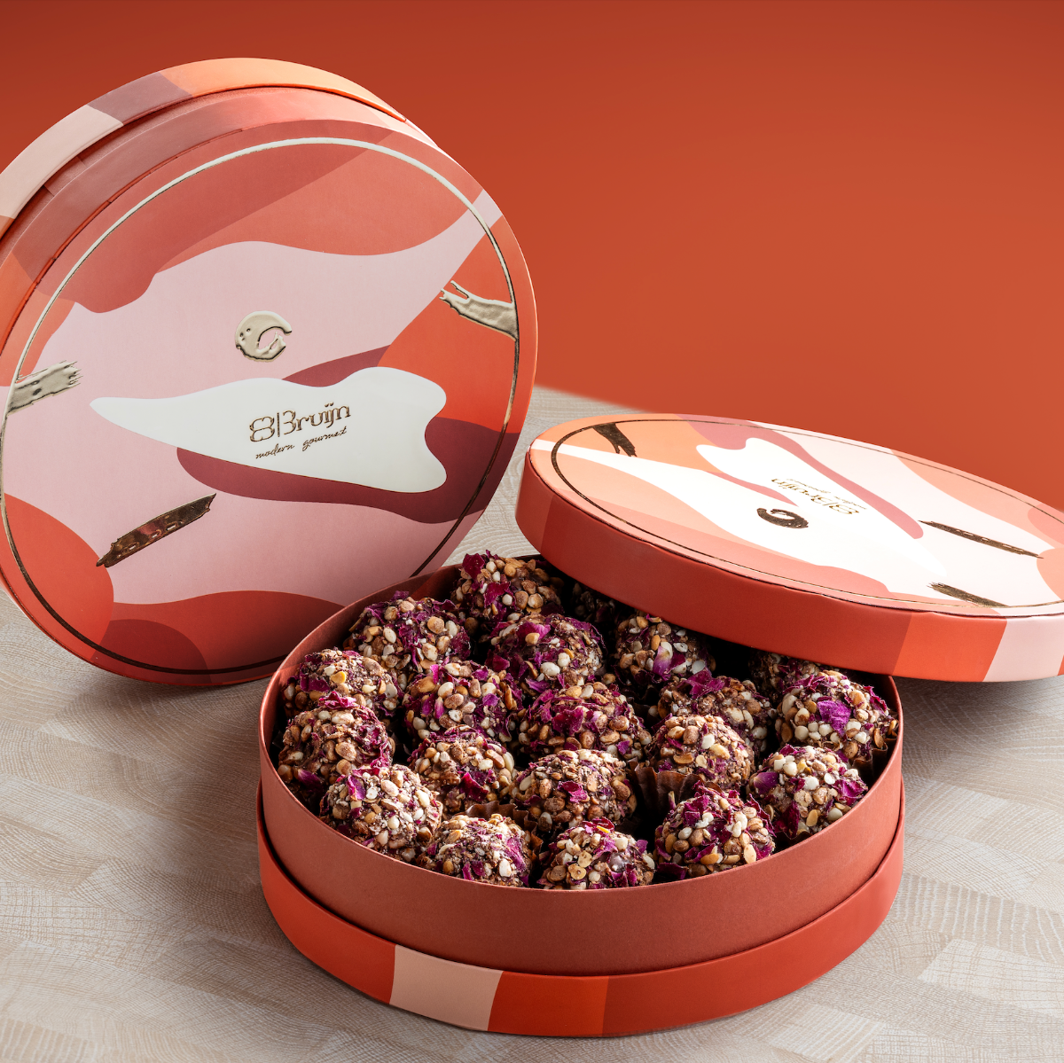 Round box with 475g date truffles encrusted with diced nuts, peanut butter & almondette.