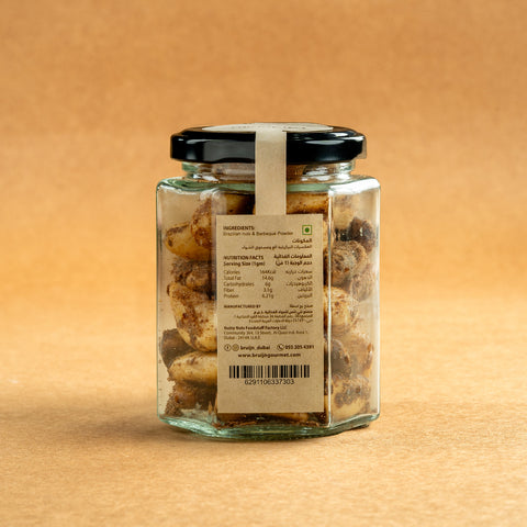 Glass jar of Bruijn Hickory Smoked Brazil Nuts with black lid and kraft label, filled with large Brazil nuts infused with smoky hickory flavour.