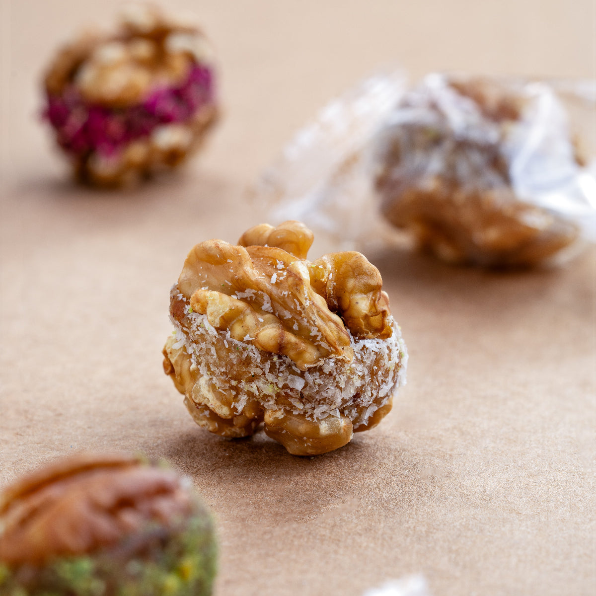 Close-up of Chilean walnut bite stuffed with dates, figs & cranberry, individually wrapped for freshness.