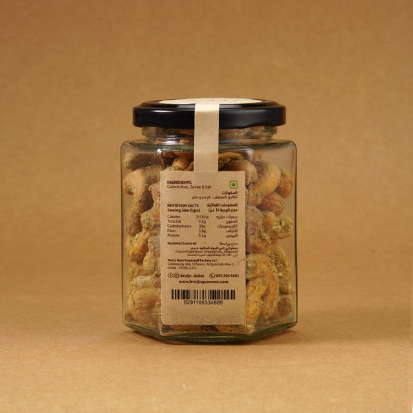 Glass jar of Bruijn Za’atar Cashews with spiced cashews inside and product details label.